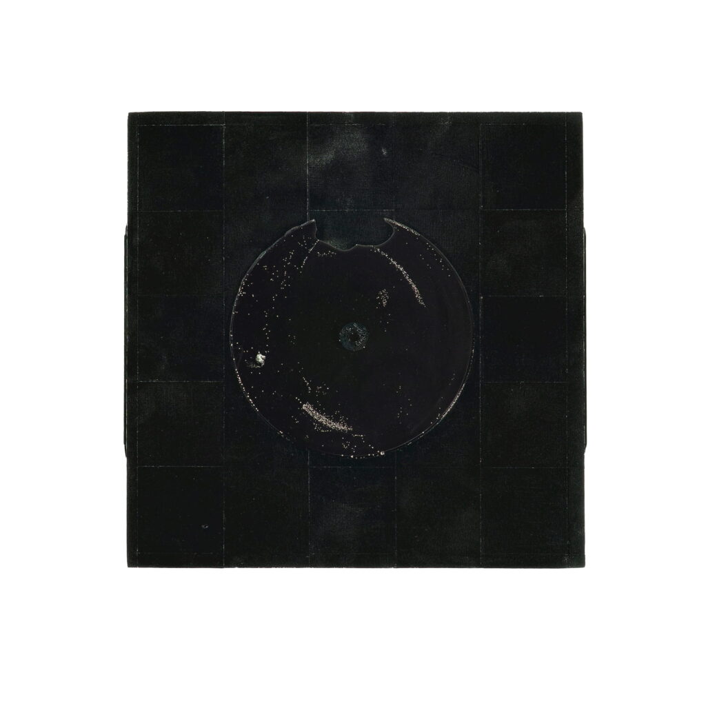 Wall sculpture S-024 by Richard Figueras, a 7.5 x 7.75 x 2 inch poplar piece featuring acrylic paint and an epoxy disk, shown as a black square panel with a circular textured element at the center.