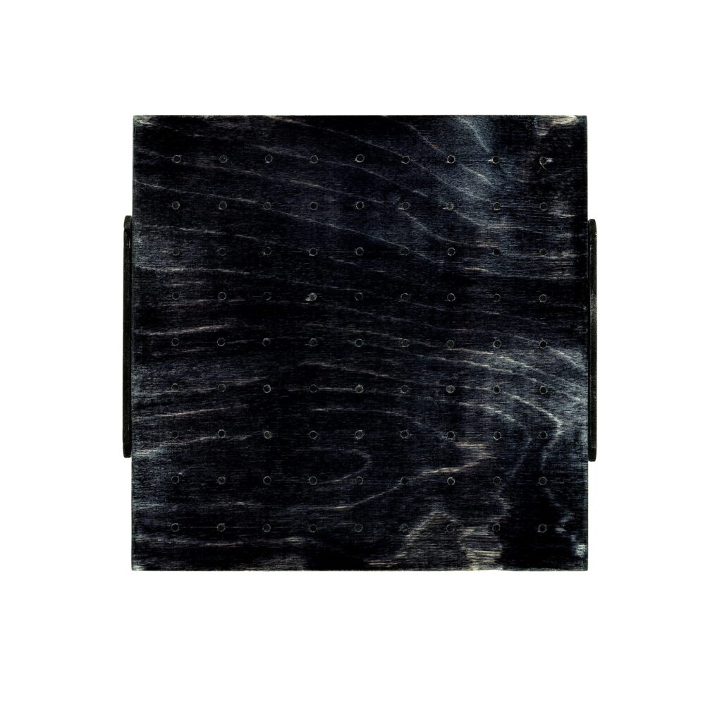 Wall sculpture S-027 by Richard Figueras, a 7.5 x 7.75 x 0.875 inch piece made of birch plywood with woodstain and welded rod featuring a dark stained wooden square with small circular holes arranged in a grid pattern